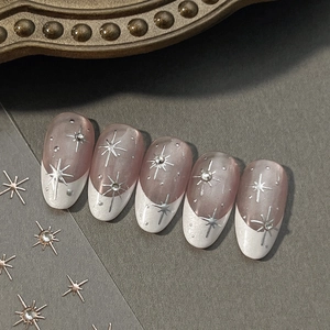 Sparkling French press-on nails with silver star pattern and crystal rhinestone accents