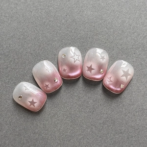 Pink and white ombre star nail stickers with cat eye glitter finish and rhinestones
