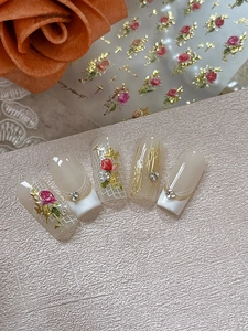 Detailed view of vintage 3D rose nail stickers with pearl and rhinestone accents