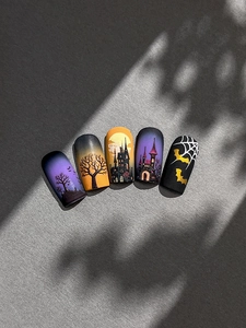 Detail of Halloween press-on nails featuring gothic castle silhouettes and bats