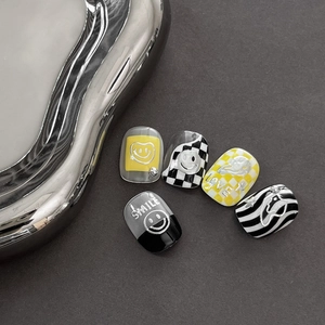 Graffiti style nail stickers with yellow smiles, checkerboard patterns and LOVE text