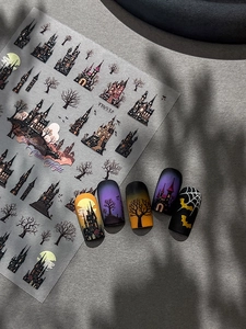 Detail of Halloween nail stickers with gothic castle and bat patterns on nails