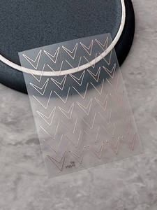 Macro shot of rose gold V-shaped geometric line nail stickers YT5515 on clear sheet