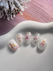 Detail of 3D Christmas nail art charms with snowflakes and gingerbread man patterns