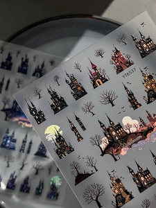 Macro view of Gothic Halloween nail stickers featuring embossed castles and laser bats
