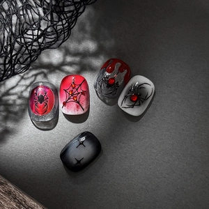 Halloween press-on nails with silver laser 3D spider webs and red rhinestone accents