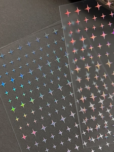 Detailed view of laser holographic star nail stickers with reflective metallic finish