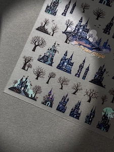 Detail of 3D embossed Halloween nail stickers featuring dark castle and bat designs