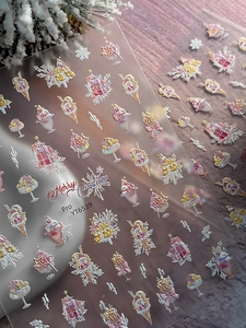 Detail of 3D embossed Christmas nail stickers with iridescent laser finish and festive patterns