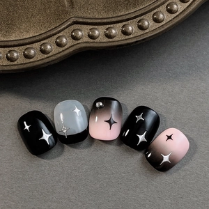 Y2K style black and pink gradient press-on nails with star patterns and small rhinestones