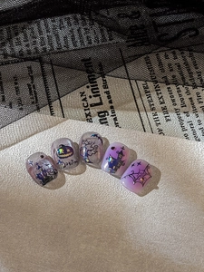 Detail of gradient Halloween nail art stickers with iridescent pumpkin and castle motifs