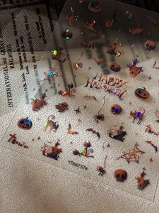 Detail of 3D holographic Halloween nail stickers with pumpkins and ghost designs