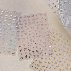 3D bow nail art stickers in blue pink and gold colors for elegant manicure decoration