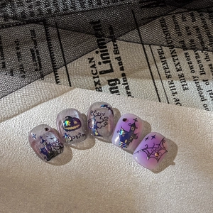 Gothic Halloween press-on nails with purple gradient, haunted castle and pumpkin designs