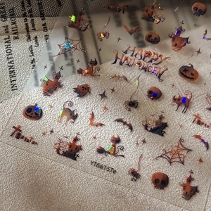 Halloween nail stickers with iridescent pumpkins, bats, and cats on a vintage background