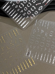 Macro view of 5D skeleton nail stickers in white, gold, and silver for Halloween decor