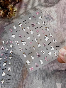 Macro view of 3D embossed Halloween nail stickers with ghost, pumpkin and bat patterns