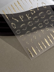 3D embossed Halloween bone nail stickers with metallic gold and silver finish detail