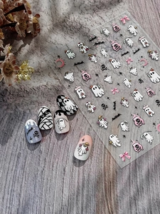 Close-up of Halloween nail stickers featuring ghost, bat, and bow relief patterns