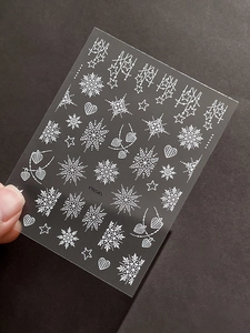 Macro detail of YT6545 3D embossed white snowflake and star nail art stickers