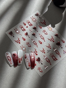 Macro view of 3D embossed Halloween nail decals with bleeding heart and silver spider web