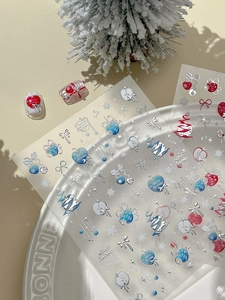 Gros plan de stickers à ongles de Noël avec sapins et cœurs argentés en relief