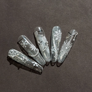Handmade silver glitter press-on nails with 3D embossed snowflakes and pearl chains