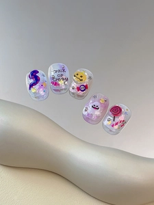 Detail of Halloween press-on nails featuring 3D ghosts, pumpkins, and glitter accents