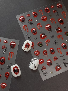Detail of Halloween 3D nail stickers featuring red lips, black spiders and scorpions