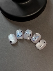 Detail of Halloween pumpkin nail stickers with pearlescent finish and star patterns