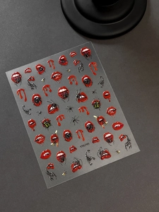 Detailed relief of gothic red lips with fangs and spider motifs for Halloween nail art