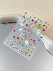 Detail shot of colorful Halloween nail art stickers with pumpkin and ghost motifs