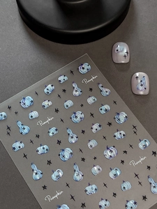 Detail of Halloween pumpkin nail stickers with light blue shell effect and star patterns