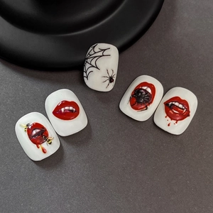 Halloween nail art decals featuring gothic spider webs and vampire red lips on white nails