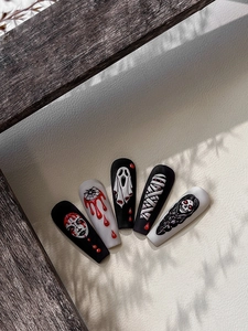 Macro detail of 3D embossed Halloween ghost face nail art stickers with relief texture