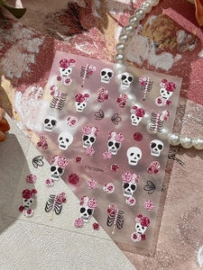Detailed relief nail sticker featuring pink roses, white skulls and gothic bone designs