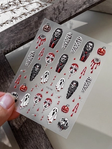Detail of 3D embossed Halloween nail stickers featuring vampires, mummies, and pumpkins