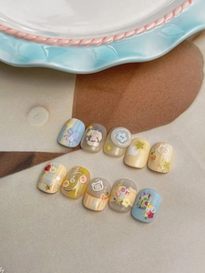 Detailed view of 3D bear and button elements on pastel relief cartoon press-on nails