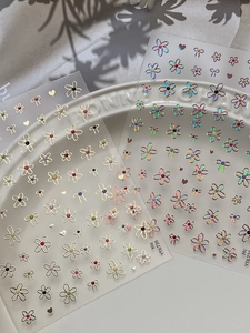Detail of floral and heart gold bronzing nail stickers with holographic butterfly designs