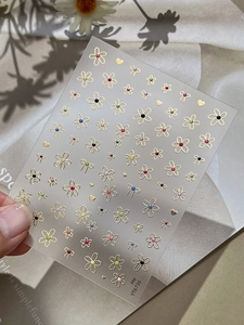 Macro detail of YT6736 nail art sticker with gold floral, heart and bow patterns