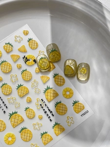 Detail of 3D embossed pineapple nail stickers and floral motifs for summer manicure