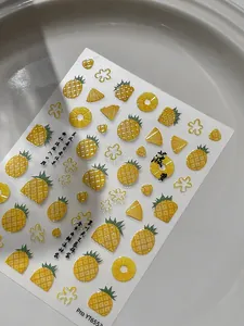 Detail of embossed pineapple nail art stickers with vivid yellow fruit and green leaf designs