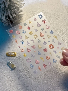 Detailed view of Christmas nail stickers with tree, snowman and gingerbread motifs