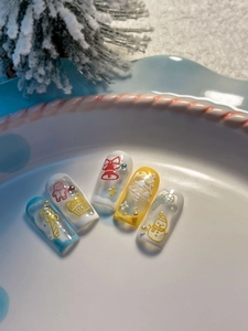 Macro view of Christmas nail stickers with 3D embossed snowmen and festive patterns