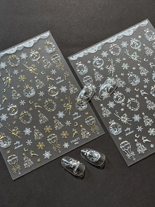 Detail view of gold and silver Christmas nail stickers with reindeer and snowflake motifs