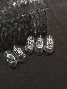 Detail of clear Christmas nail art featuring white deer, snowflakes and pearls