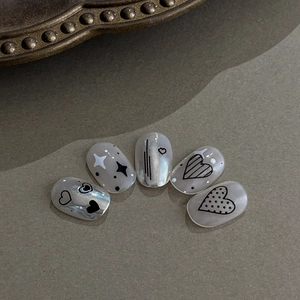 Y2K style silver and white press-on nails with embossed heart and star line patterns