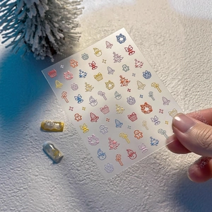 Chic 3D Christmas nail art decals with colorful trees, snowmen, and festive holiday motifs