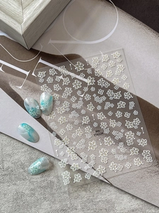 Detail of YT6224 floral nail stickers with blue marble effect and pearl accents