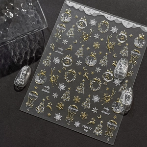 Gold and silver Christmas nail art stickers with reindeer, snowflakes, and tree designs